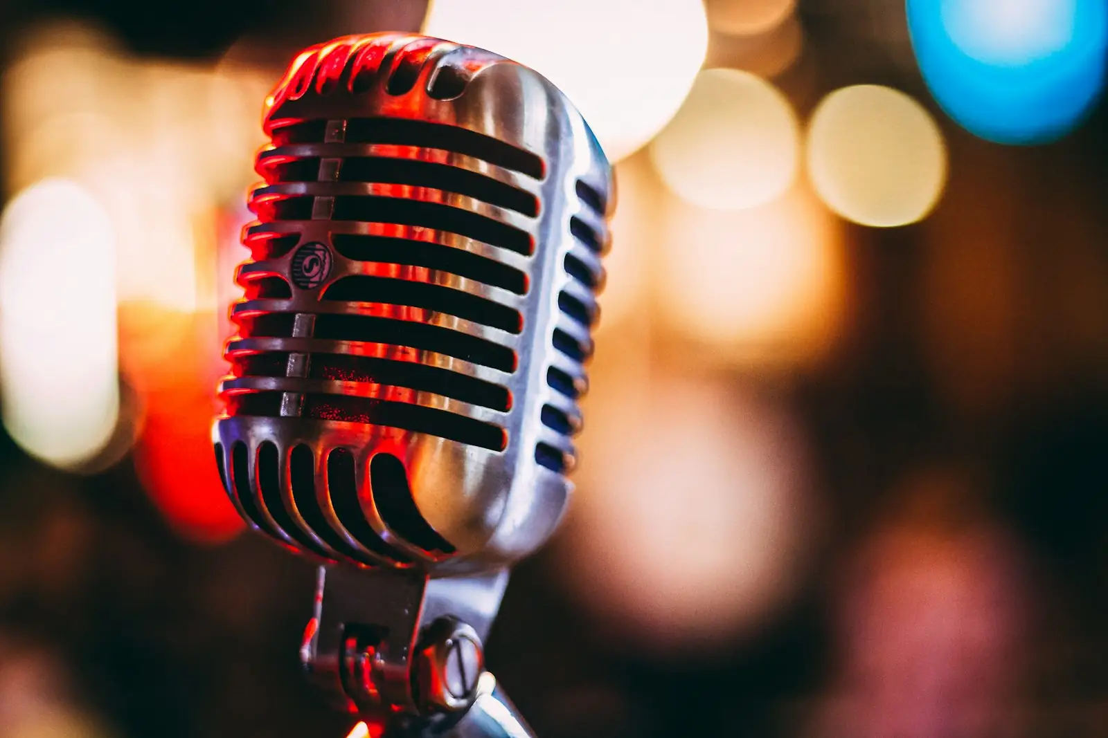 A vintage microphone in red and amber light.
