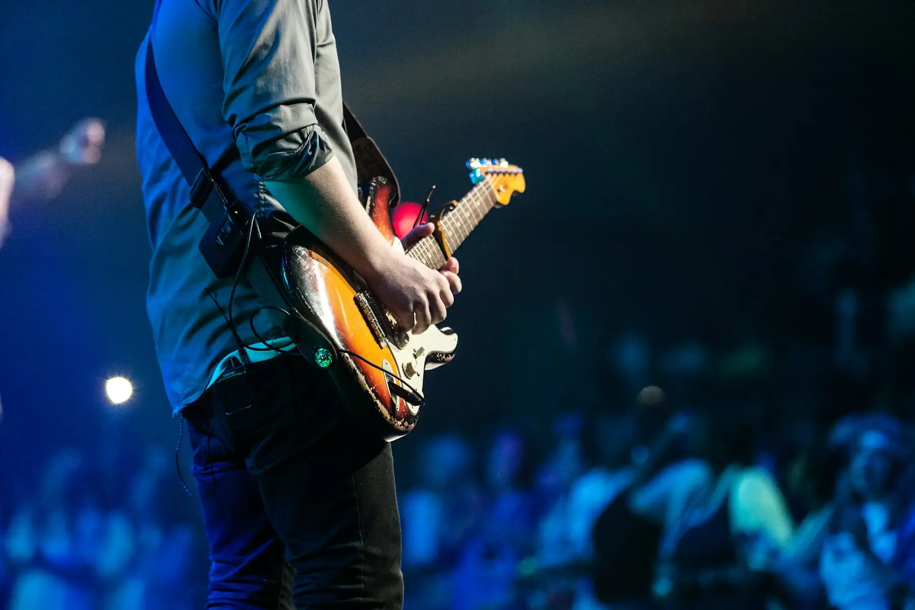 Hands raised in a crowd at a concert.